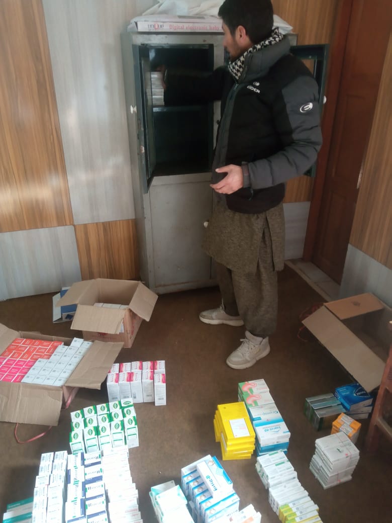 A volunteer sorting a new delivery of medicine